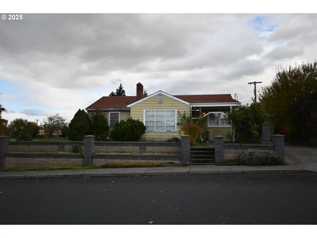 a front view of house with wooden fence