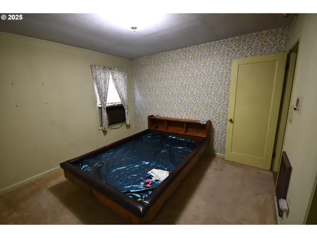 a view of an empty room and wooden floor