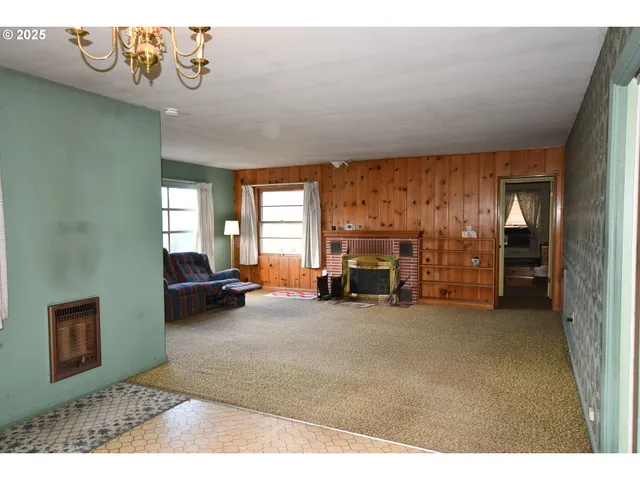 a view of a livingroom with furniture and a fireplace