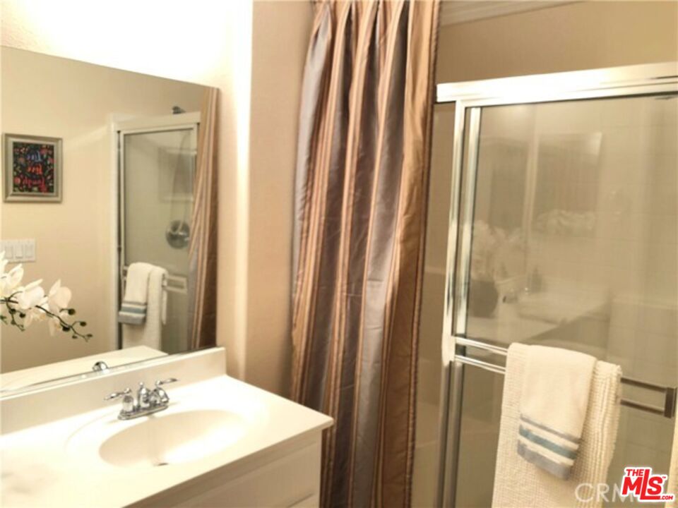 9497 Jack Rabbit Drive, Unit 106 Rancho Cucamonga, CA 91730 - Photo 11 of 14 a bathroom with a sink and a mirror