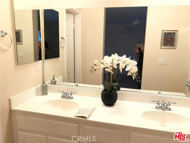 a bathroom with a sink vanity and a mirror