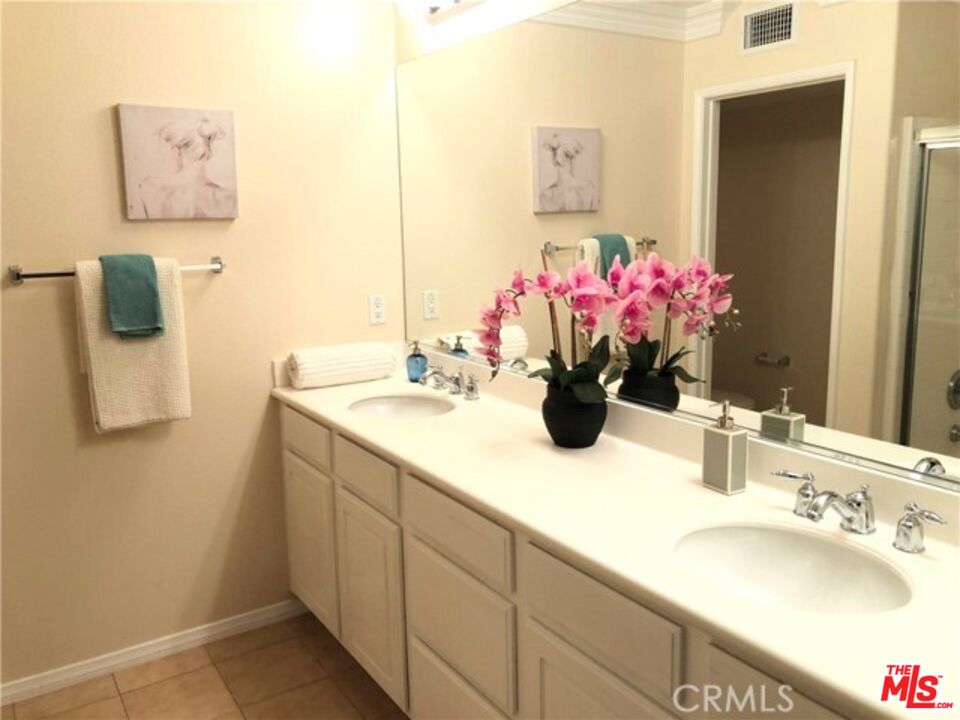 9497 Jack Rabbit Drive, Unit 106 Rancho Cucamonga, CA 91730 - Photo 14 of 14 a bathroom with a sink vanity and a mirror