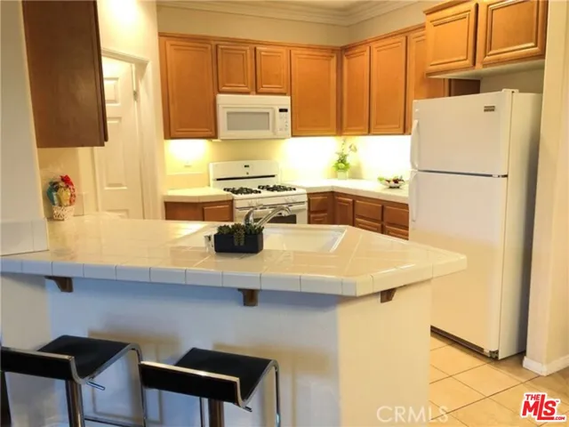 a kitchen with a refrigerator a stove a sink and a counter