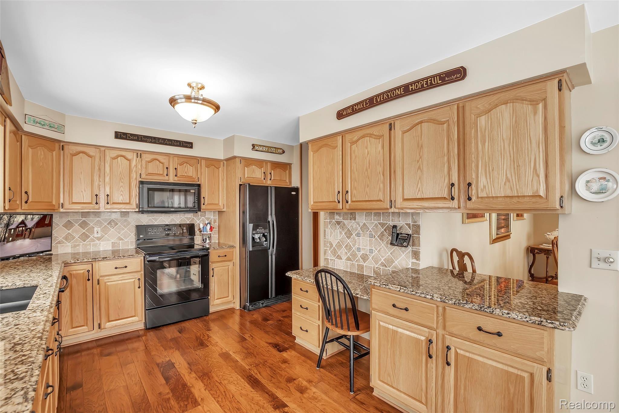 13413 White Lake Road Fenton, MI 48430 - Photo 8 of 27 Newly Renovated Kitchen with Bella Cera Hand-scraped Hardwood, Granite Counter Tops and Marble Backsplash.