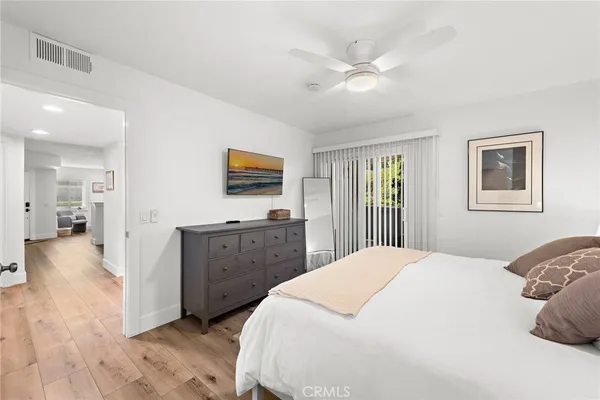 a spacious bedroom with a bed and a dresser