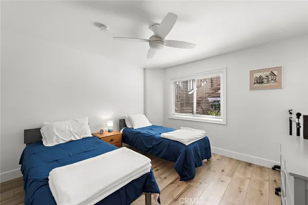 a bedroom with two beds and a window