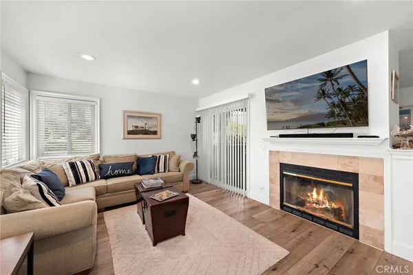 a living room with furniture and a fireplace