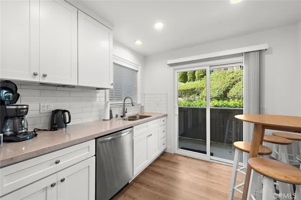 a kitchen with a sink and wooden cabinets