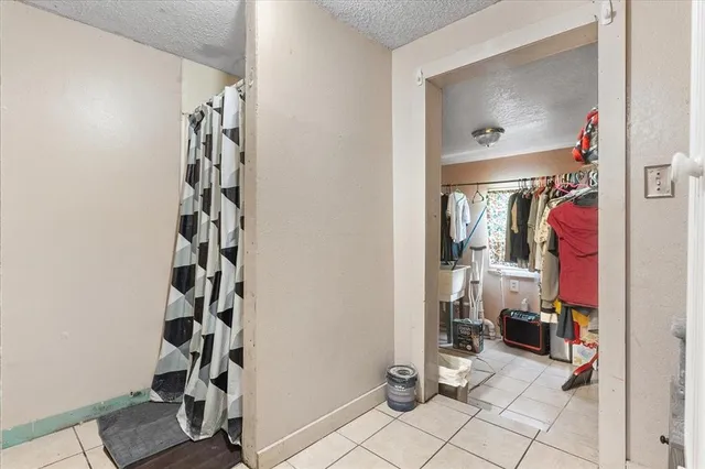 walk in closet with white walls