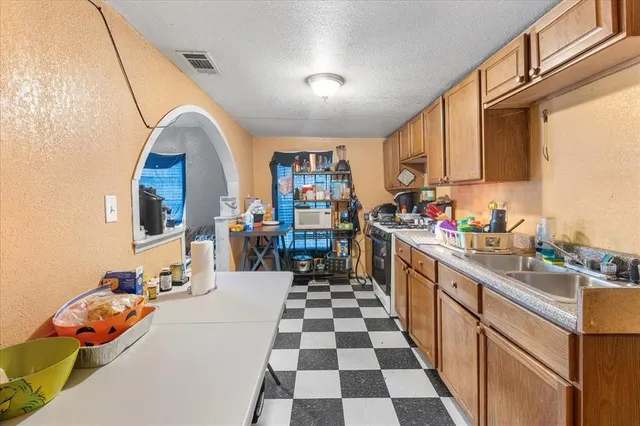 a kitchen with stainless steel appliances granite countertop a sink and cabinets