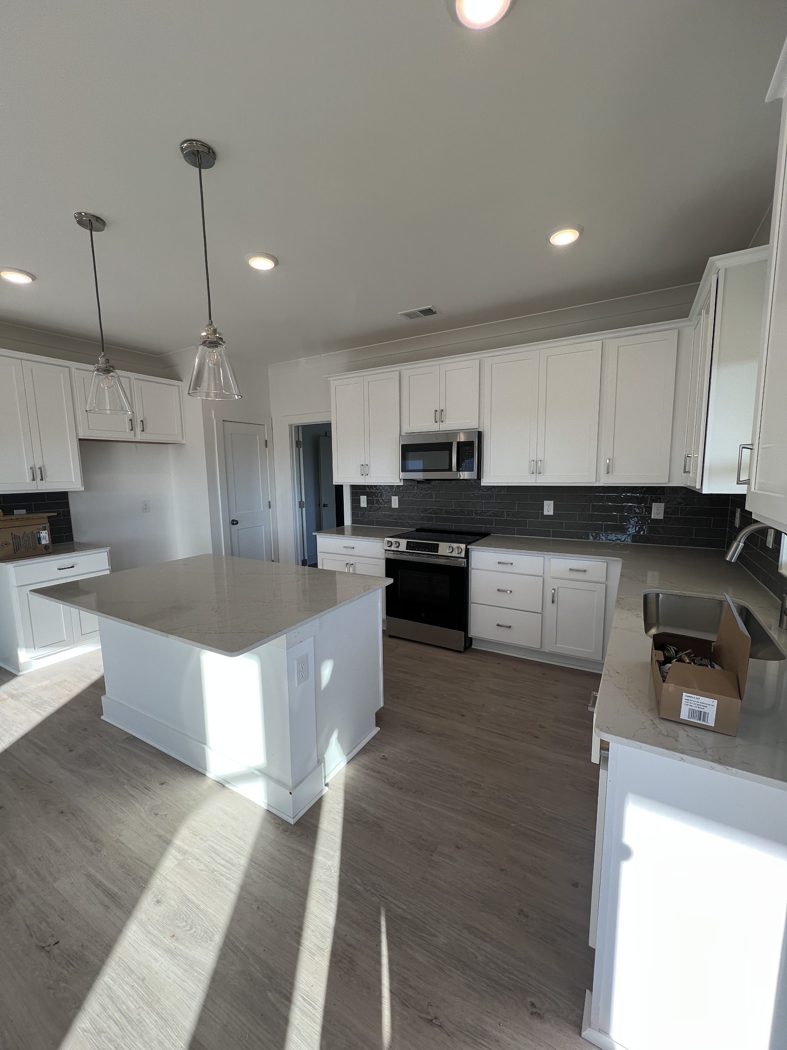 309 Strong Street Columbia, TN 38401 - Photo 3 of 33 a large kitchen with kitchen island a sink a stove a oven a center island and cabinets