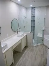 a bathroom with a sink a toilet and shower