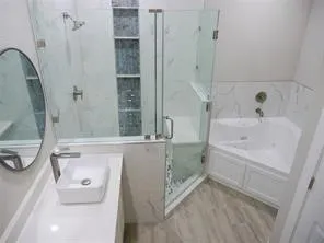 a bathroom with a tub sink and mirror