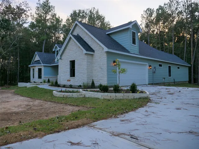 a view of a house with yard and a garden