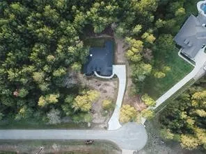 an aerial view of a house with yard