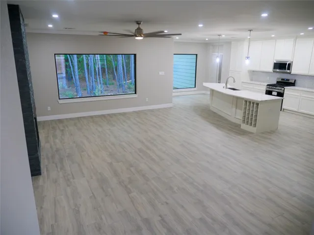 a view of kitchen with cabinets and wooden floor