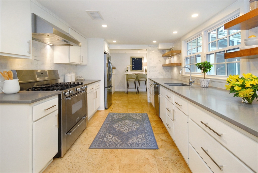 213 Nashoba Road Concord, MA 01742 - Photo 11 of 33 a kitchen with stainless steel appliances granite countertop sink stove and cabinets