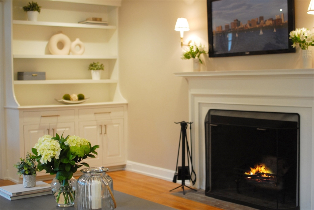 213 Nashoba Road Concord, MA 01742 - Photo 18 of 33 a living room with a fireplace and a potted plant