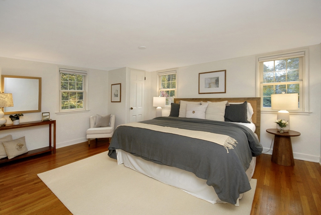 213 Nashoba Road Concord, MA 01742 - Photo 19 of 33 a bedroom with a bed and wooden floor