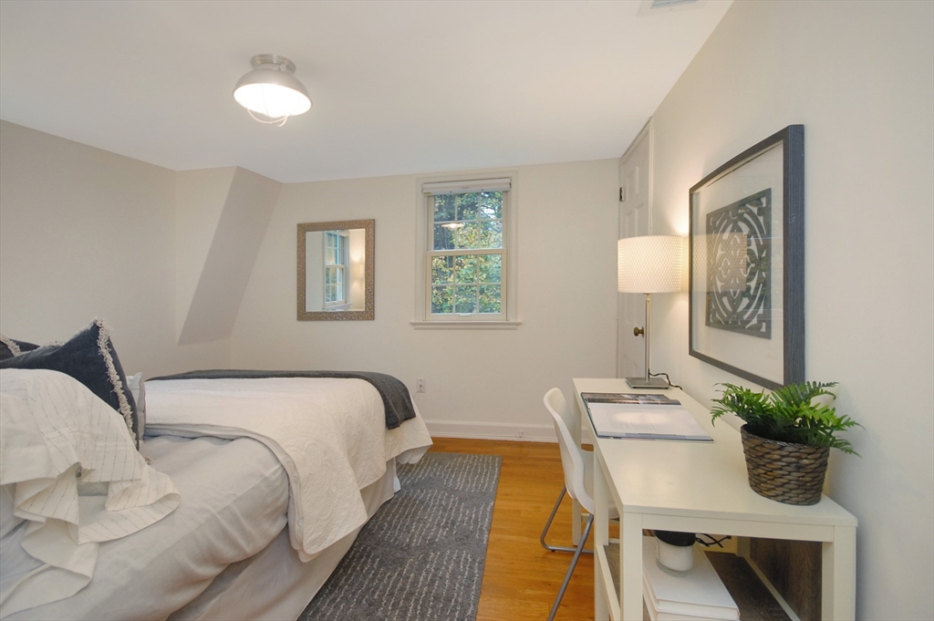 213 Nashoba Road Concord, MA 01742 - Photo 20 of 33 a bedroom with a bed and a table in it
