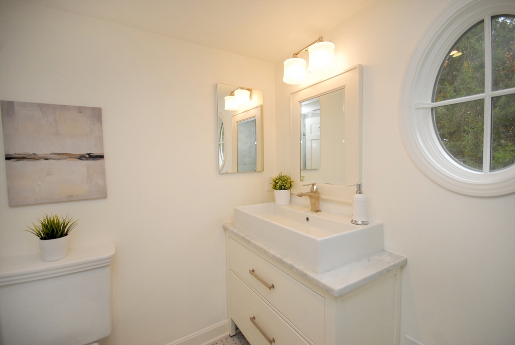 213 Nashoba Road Concord, MA 01742 - Photo 23 of 33 a bathroom with a sink a toilet and a mirror