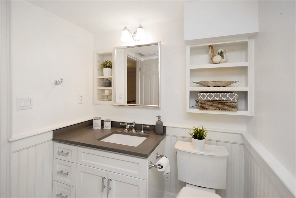 213 Nashoba Road Concord, MA 01742 - Photo 25 of 33 a bathroom with a sink a vanity and a window