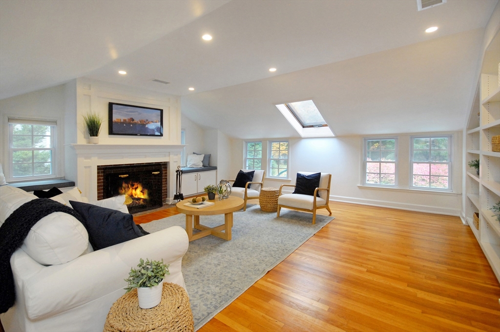 213 Nashoba Road Concord, MA 01742 - Photo 26 of 33 a living room with furniture and a fireplace