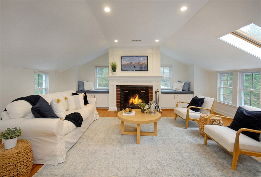 213 Nashoba Road Concord, MA 01742 - Photo 27 of 33 a living room with furniture and a fireplace