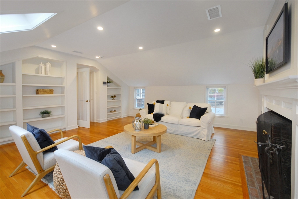213 Nashoba Road Concord, MA 01742 - Photo 28 of 33 a living room with furniture a fireplace and a flat screen tv