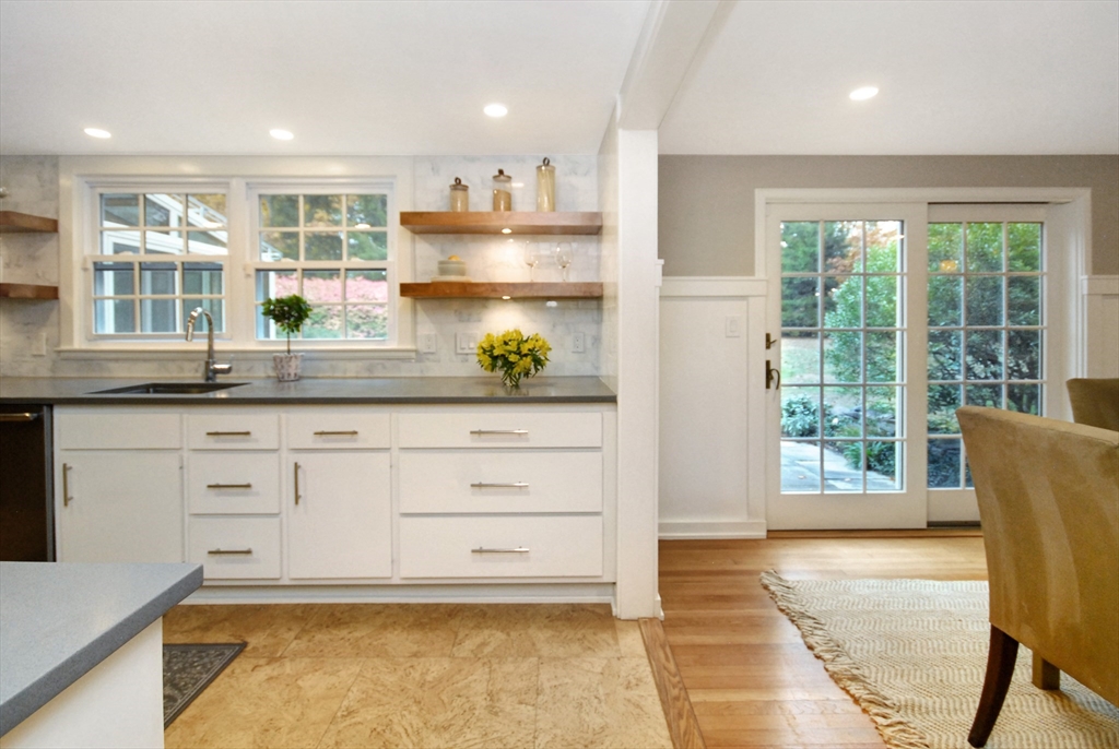 213 Nashoba Road Concord, MA 01742 - Photo 10 of 33 a kitchen with granite countertop wooden cabinets and stainless steel appliances