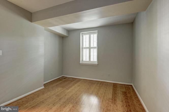 3500 39th Street Northwest, Unit B668 Washington, DC 20016 - Photo 13 of 30 an empty room with wooden floor and windows