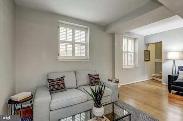 a view of a livingroom with furniture and a window