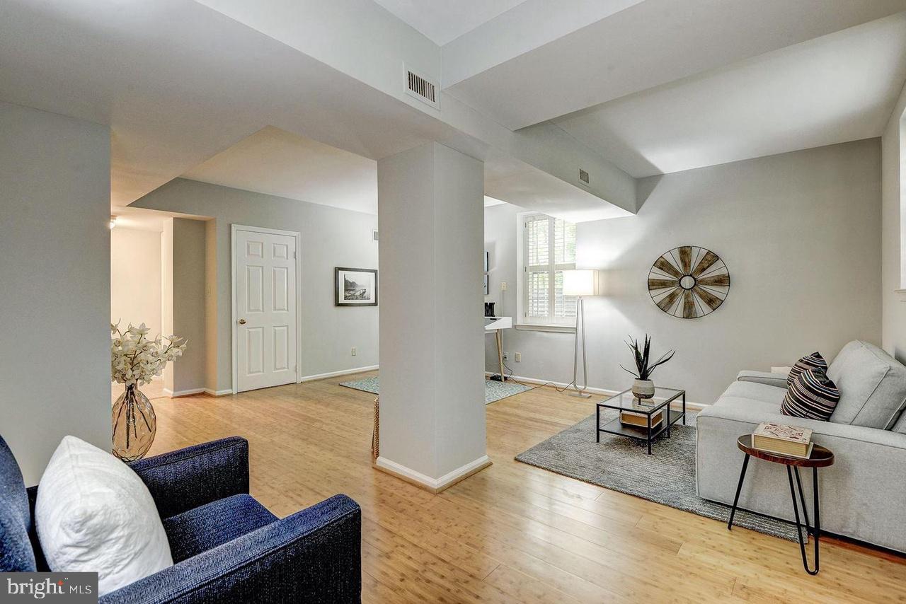 3500 39th Street Northwest, Unit B668 Washington, DC 20016 - Photo 20 of 30 a living room with furniture and a wooden floor