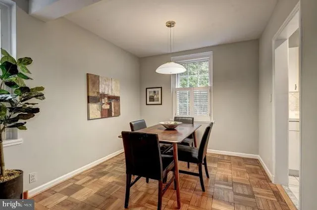 a view of a dining room with furniture and a window