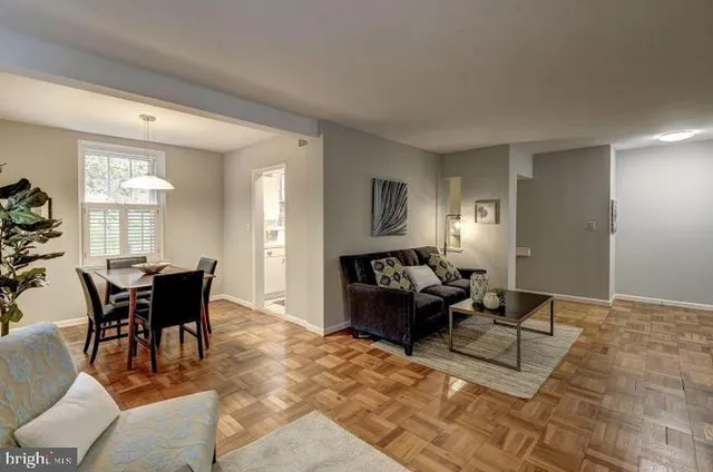 a living room with furniture a dining table and a window