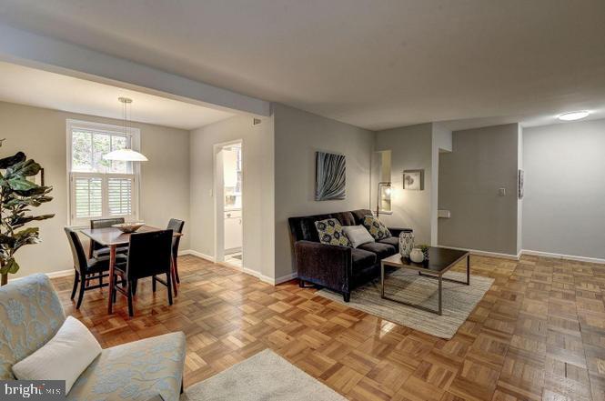 3500 39th Street Northwest, Unit B668 Washington, DC 20016 - Photo 7 of 30 a living room with furniture a dining table and a window
