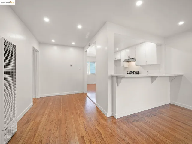a view of kitchen with cabinets and wooden floor