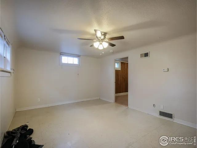 a view of an empty room with a ceiling fan
