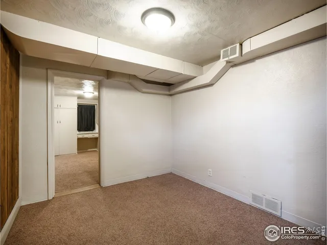 a view of a hallway with wooden shelves