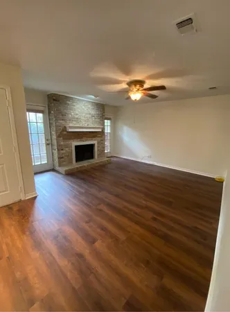 wooden floor fireplace and natural light in room