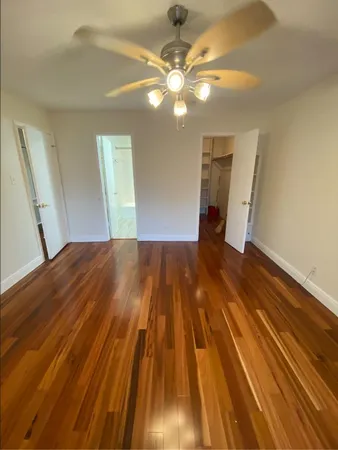 a view of a room with wooden floor and staircase