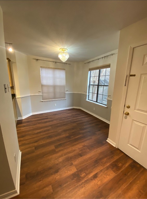 2906 West Avenue, Unit 4 Austin, TX 78705 - Photo 3 of 16 an empty room with wooden floor and windows