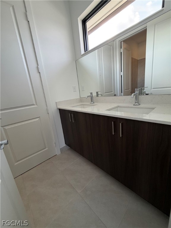 5166 Julienne Road Immokalee, FL 34142 - Photo 23 of 29 a bathroom with a sink and mirror