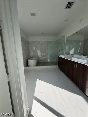 a bathroom with a sink vanity mirror and toilet