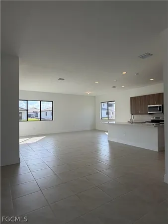 a view of a kitchen with a sink and a refrigerator