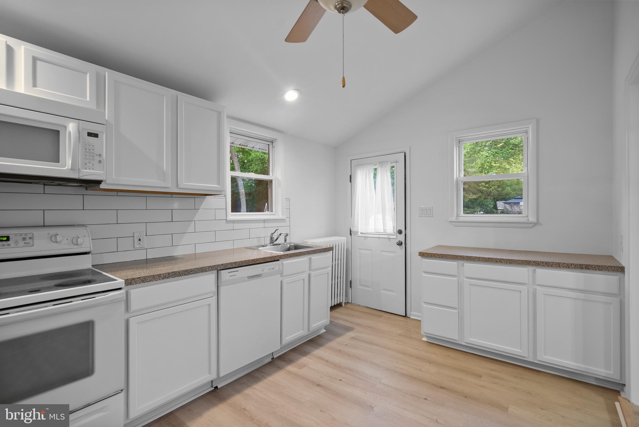 99 Chews Landing Road Clementon, NJ 08021 - Photo 11 of 37 a kitchen with white cabinets appliances a sink and a window