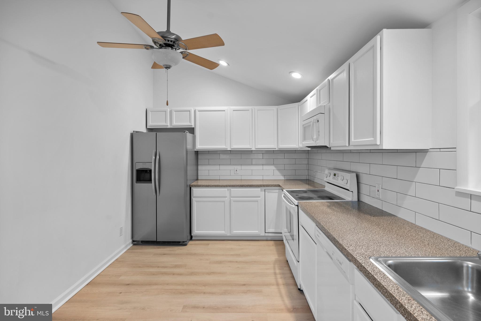 99 Chews Landing Road Clementon, NJ 08021 - Photo 12 of 37 a kitchen with a sink stainless steel appliances and cabinets