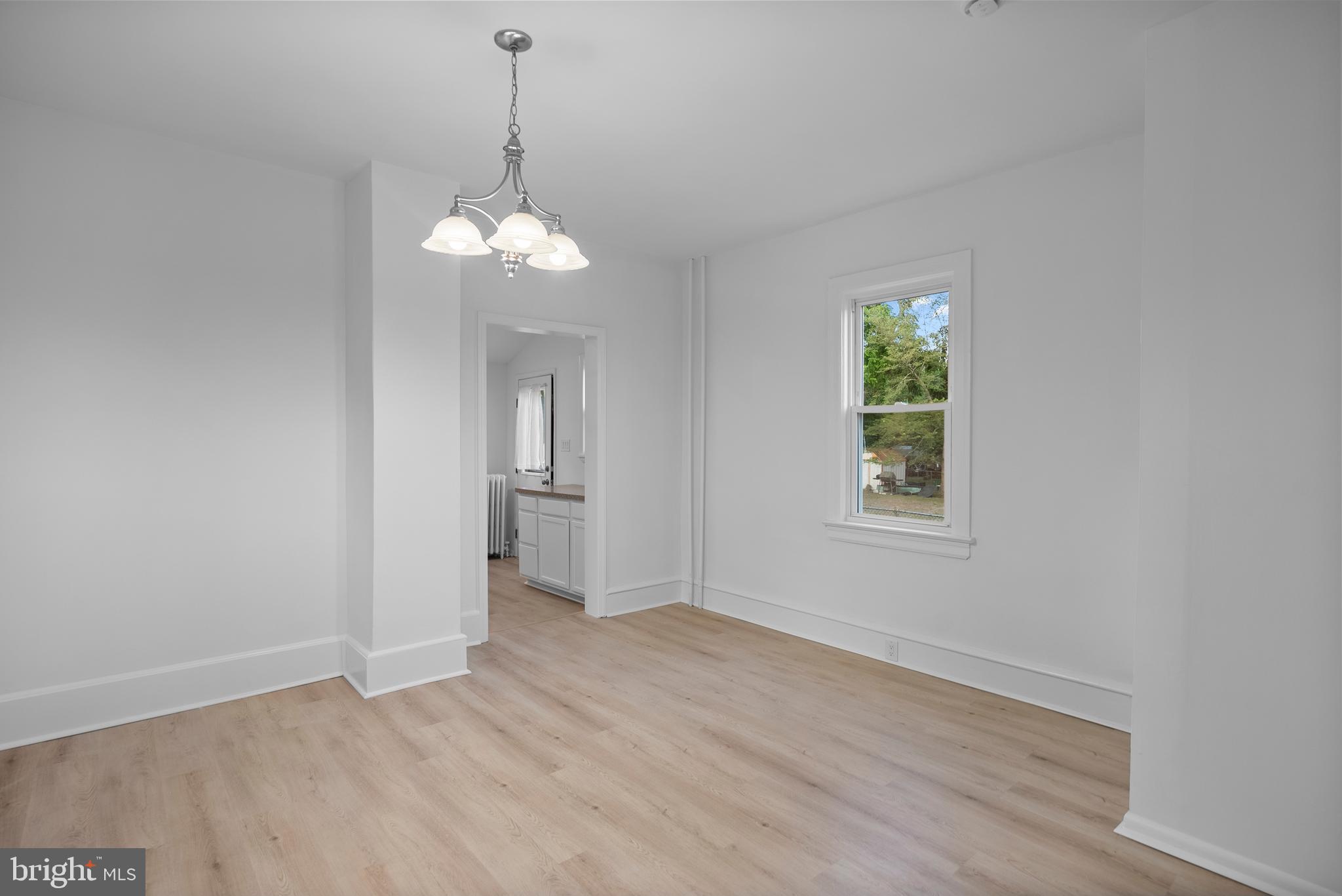 99 Chews Landing Road Clementon, NJ 08021 - Photo 9 of 37 a view of a room with wooden floor chandelier and windows