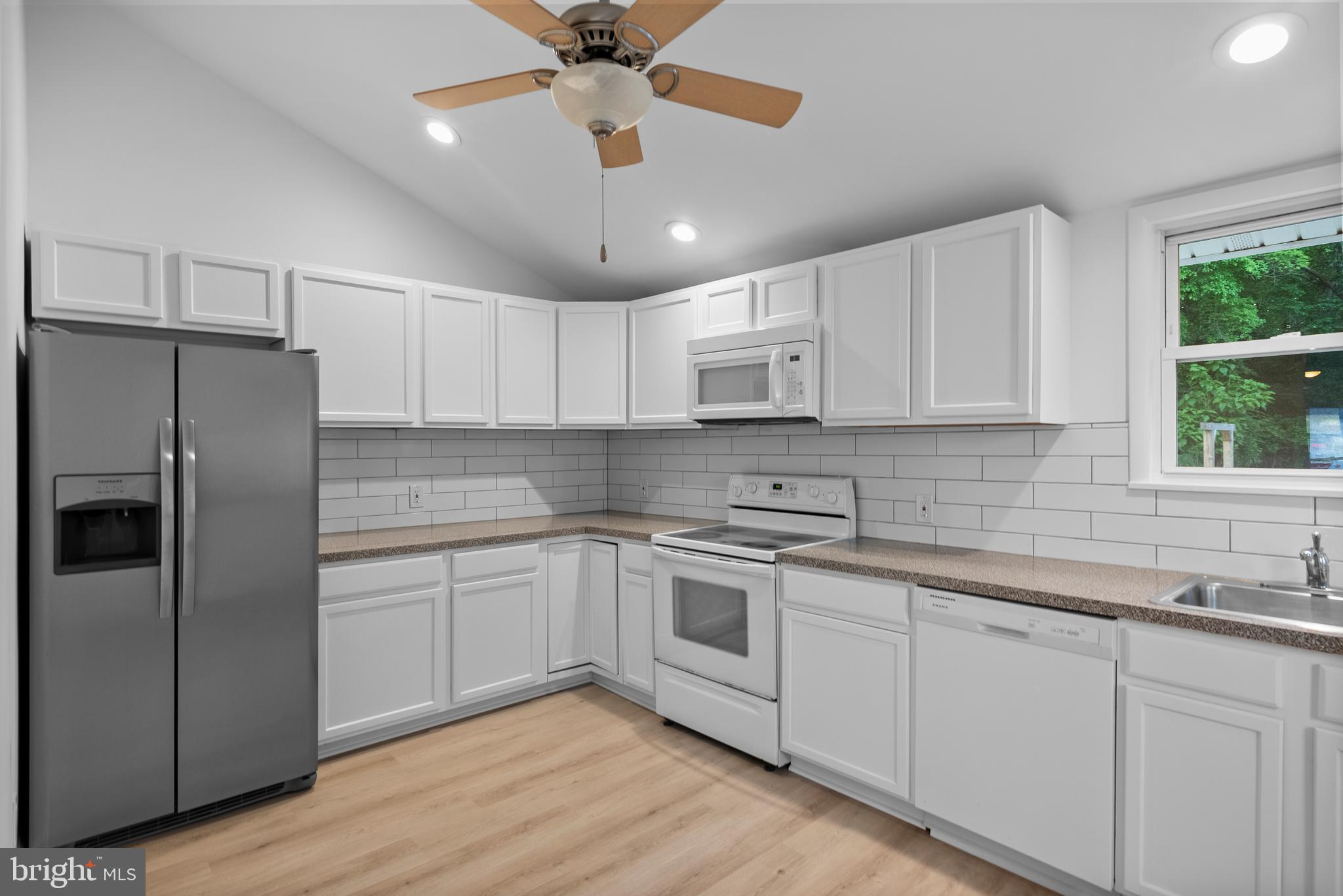 99 Chews Landing Road Clementon, NJ 08021 - Photo 10 of 37 a kitchen with stainless steel appliances a refrigerator a sink and white cabinets