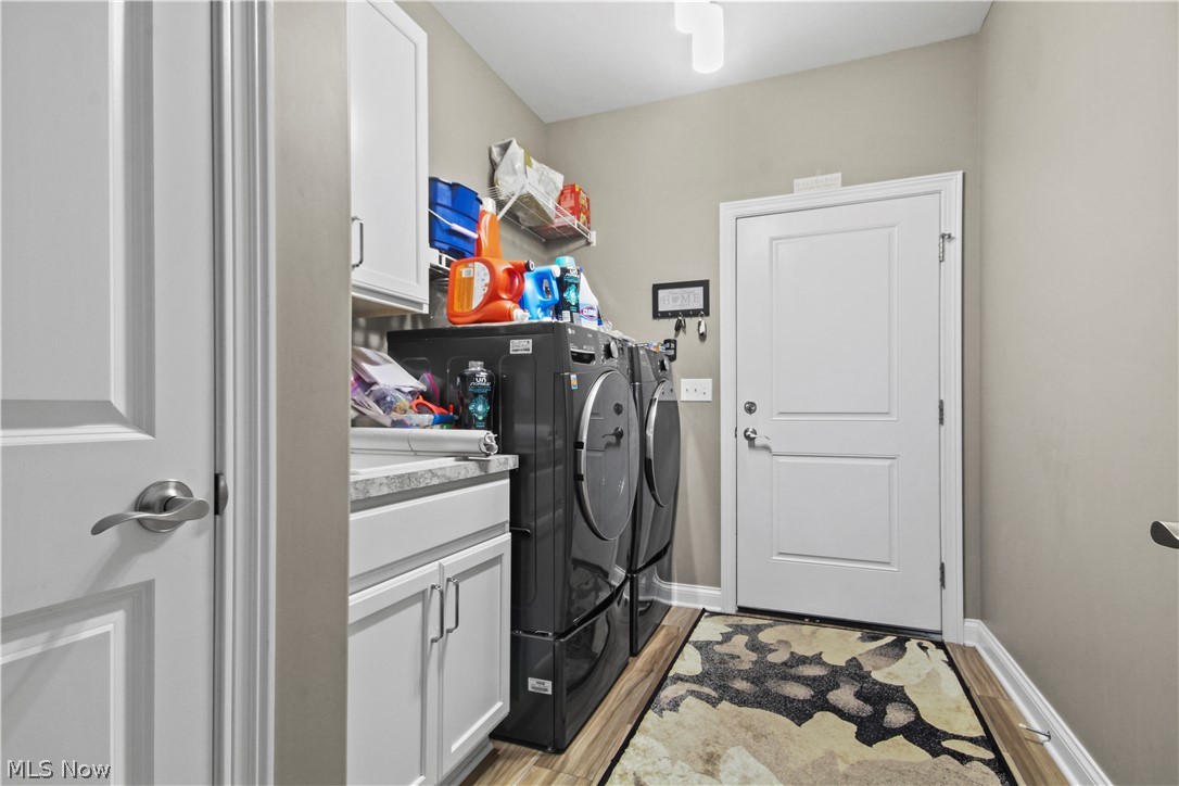 1805 East Western Reserve Road Youngstown, OH 44514 - Photo 16 of 31 Laundry room featuring light hardwood / wood-style flooring, cabinets, and washer and clothes dryer